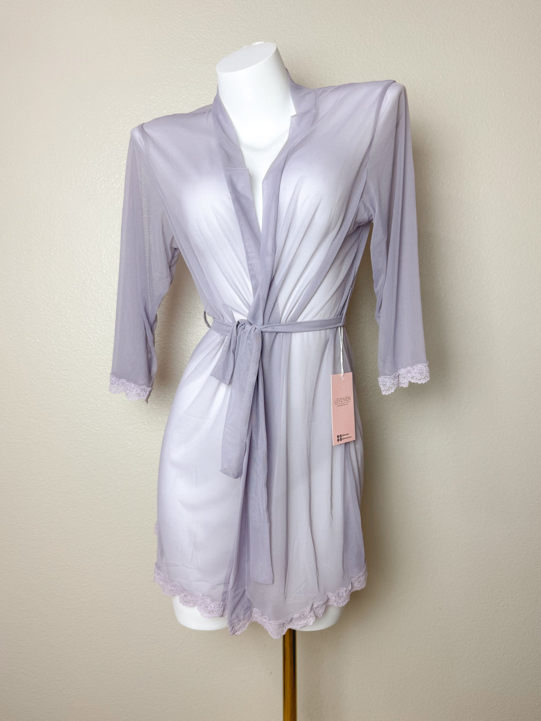 Light purple robe on a mannequin with a beige background