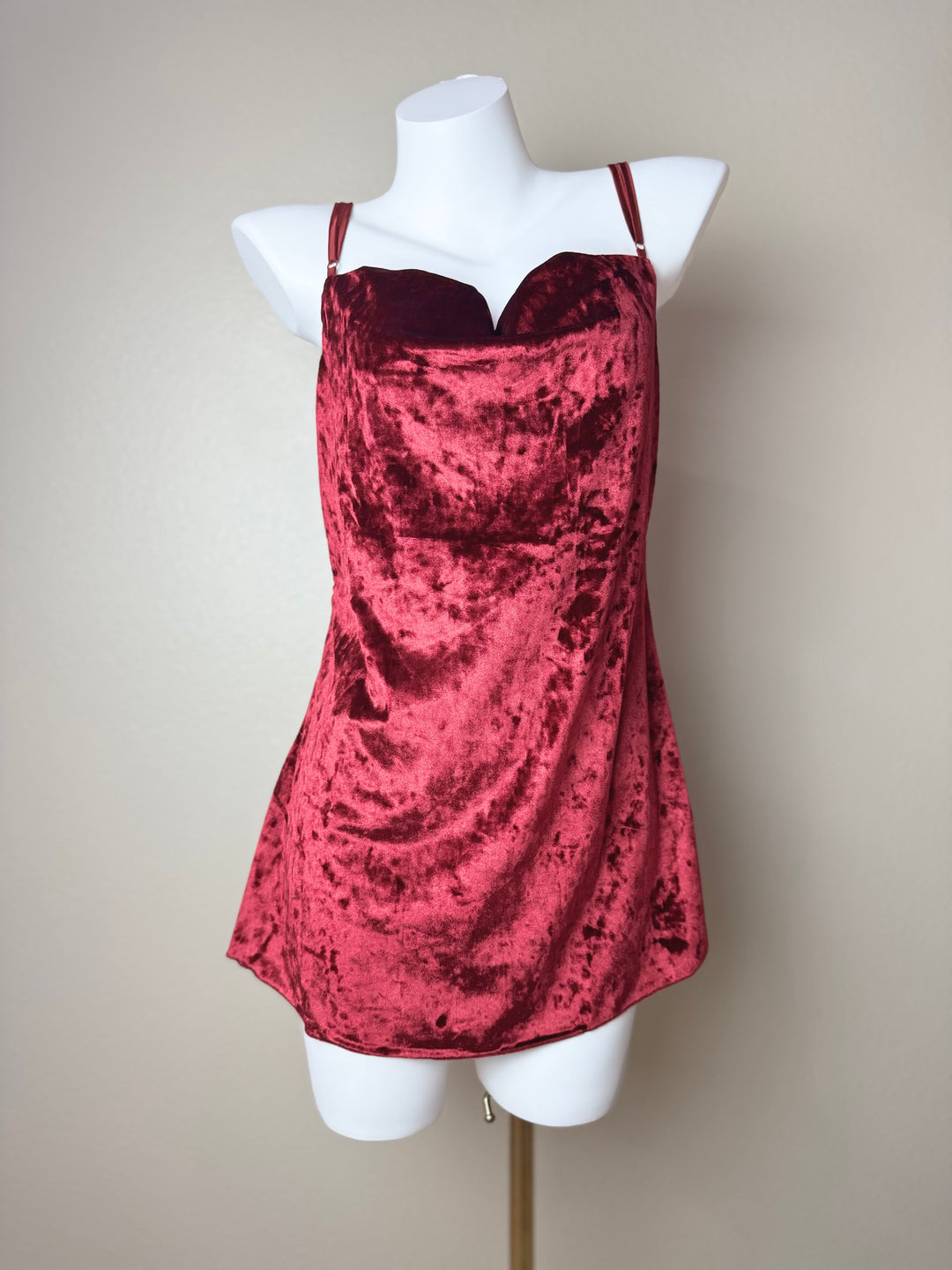 front of a red Velvet Butterfly Back Slip dress on a mannequin against a beige background
